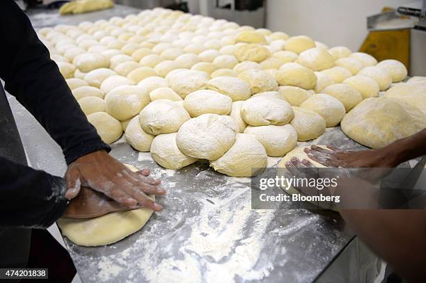 Employees knead portions of dough with their hands at the Tan Ek Tjoan bread factory in Ciputat, Banten Province, Indonesia, on Wednesday, May 20,...