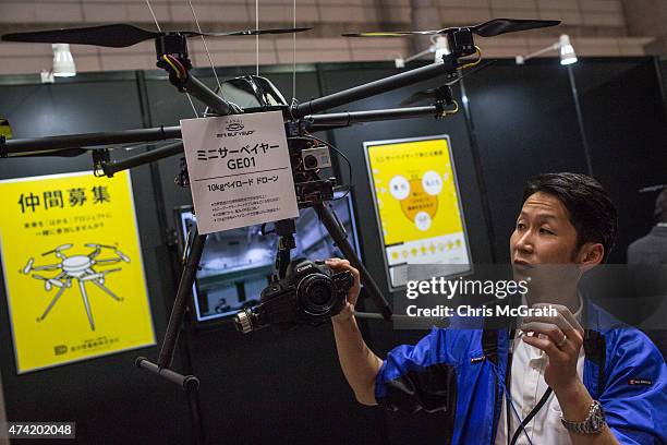 Man gives a demonstration of a drone at the International Drone Expo 2015 at Makuhari Messe on May 21, 2015 in Chiba, Japan.