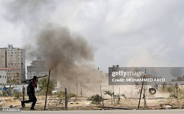 Member of the Palestinian Hamas security forces runs holding a rocket propelled grenade during their military training graduation ceremony in Gaza...