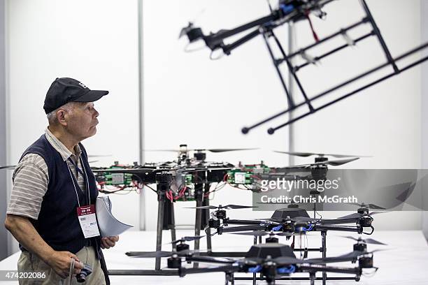 Man looks at drones on display at the International Drone Expo 2015 at Makuhari Messe on May 21, 2015 in Chiba, Japan.