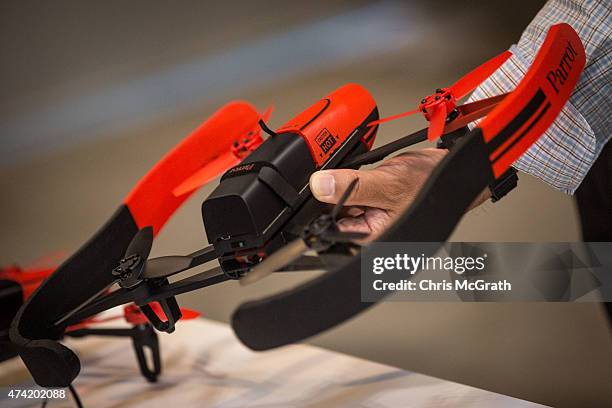 Man handles a mini drone on display at the International Drone Expo 2015 at Makuhari Messe on May 21, 2015 in Chiba, Japan.