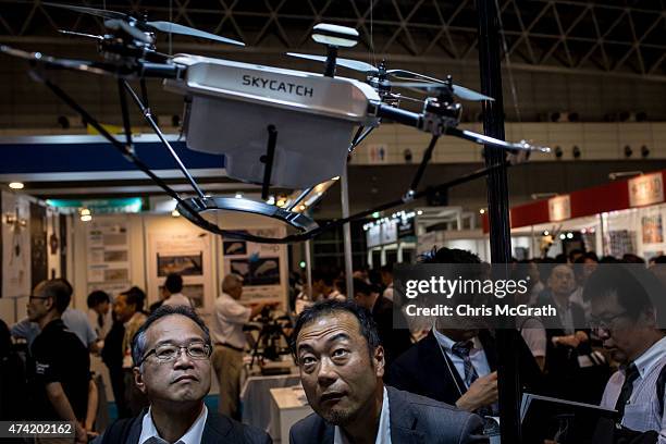 People view drones on display at the International Drone Expo 2015 at Makuhari Messe on May 21, 2015 in Chiba, Japan.
