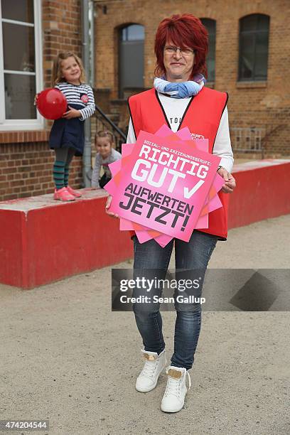 Gabi Born who is employed part-time by the town of Luebbenau in a day care center and has joined a strike organized by the ver.di labor union, poses...