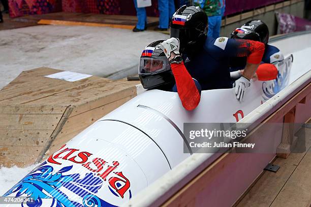 Pilot Alexander Zubkov, Alexey Negodaylo, Dmitry Trunenkov and Alexey Voevoda of Russia team 1 react after a run during the Men's Four Man Bobsleigh...