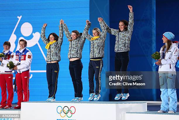 Gold medalists Vita Semerenko, Juliya Dzhyma, Valj Semerenko and Olena Pidhrushna of Ukraine celebrate during the medal ceremony for the Biathlon...