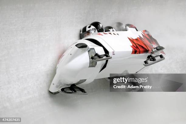 Pilot Justin Kripps, Jesse Lumsden, Cody Sorensen and Ben Coakwell of Canada team 3 crash while competing during the Men's Four Man Bobsleigh heats...