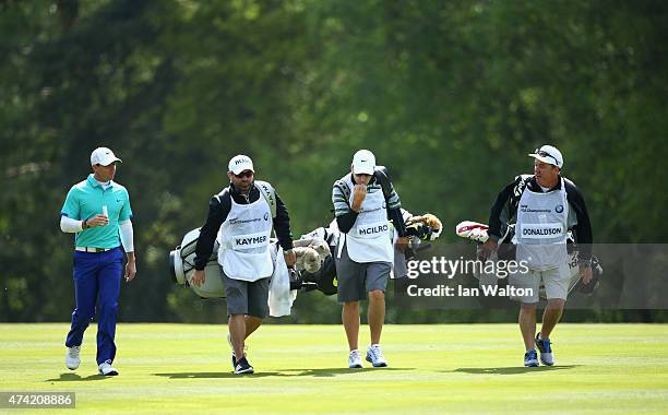 Rory McIlroy of Northern Ireland walks with caddies Craig Connelly, JP Fitzgerald and Mick Donaghy during day 1 of the BMW PGA Championship at...