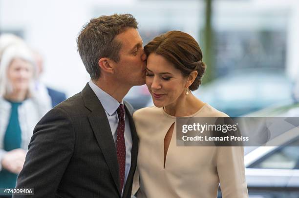 Crown Prince Frederik kisses his wife Crown Princess Mary Of Denmark as they arrive at a furniture shop during their visit to Germany on May 21, 2015...