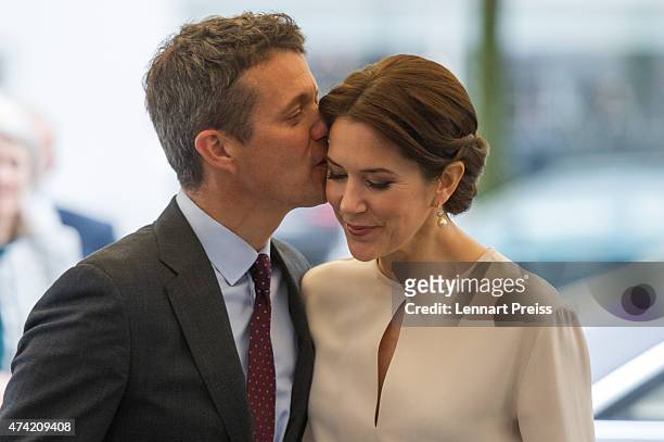 Crown Prince Frederik kisses his wife Crown Princess Mary Of Denmark as they arrive at a furniture shop during their visit to Germany on May 21, 2015...