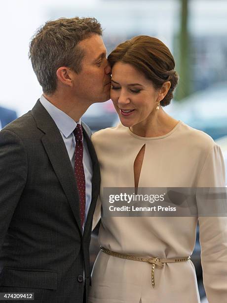 Crown Prince Frederik kisses his wife Crown Princess Mary Of Denmark as they arrive at a furniture shop during their visit to Germany on May 21, 2015...