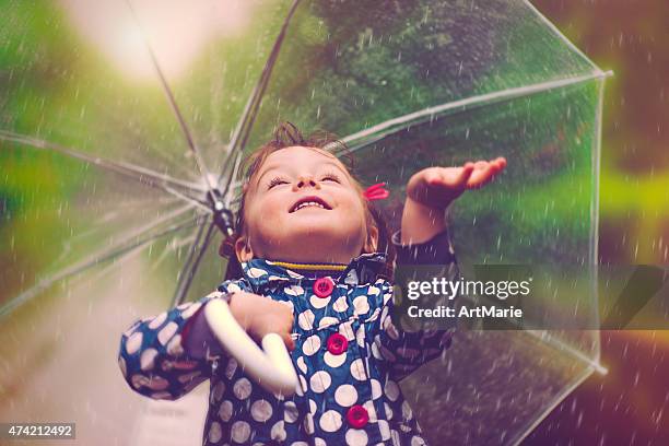 happy in rain - child umbrella stockfoto's en -beelden