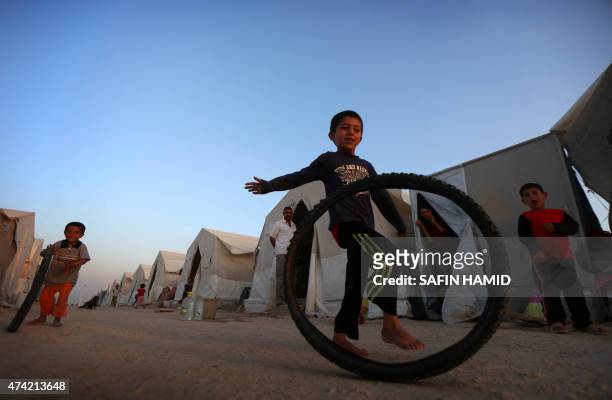 Displaced Iraqis boys from the Yazidi community, who fled violence between Islamic State group jihadists and Peshmerga fighters in the northern Iraqi...