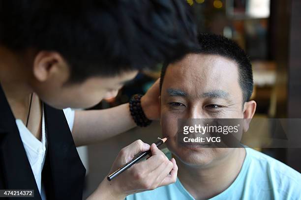 Thirty-year old husband in makeup on Network Valentine's Day on May 20, 2015 in Zhengzhou, Henan province of China. A couple of lovers over thirty...