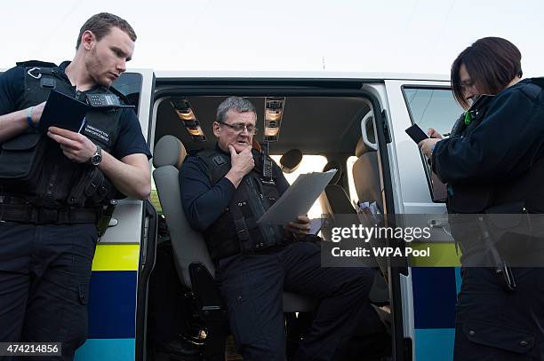 Immigration enforcement officer John Keane briefs his colleagues on the occupants of the houses they are about to raid for illegal immigrants, on May...