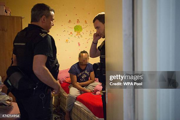 Sri Lankan man is interviewed by Immigration Enforcement officers after a raid on a residential property looking for illegal immigrants in Southall,...