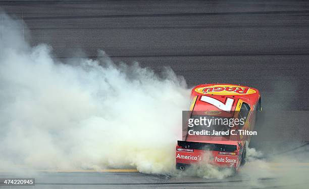 Regan Smith, driver of the Ragu Chevrolet, celebrates with a burnout after winning the NASCAR Nationwide Series DRIVE4COPD 300 at Daytona...