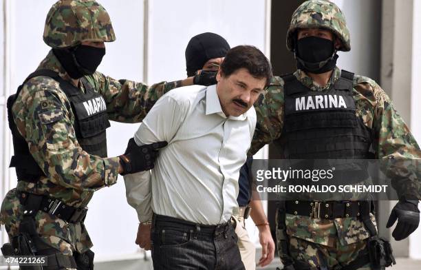 Mexican drug trafficker Joaquin Guzman Loera aka "el Chapo Guzman" , is escorted by marines as he is presented to the press on February 22, 2014 in...