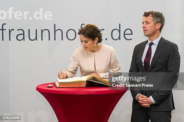 Crown Prince Frederik and Crown Princess Mary Of Denmark sign the Golden Book of the Fraunhofer Institut during their visit to Germany on May 21,...