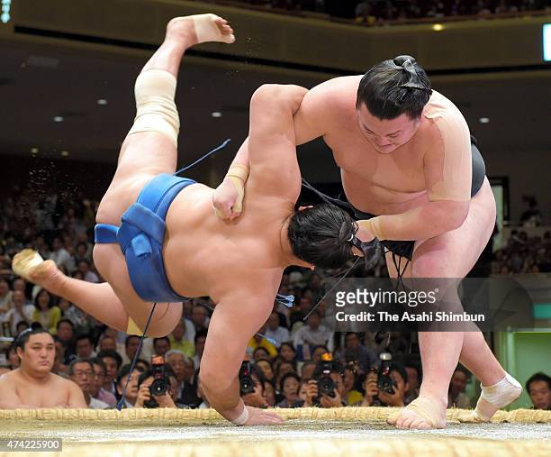 Ikioi throws Mongolian wrestler Kyokushuho during day twelve of the Grand Sumo Summer Tournament at Ryogoku Kokugikan on May 21, 2015 in Tokyo, Japan.