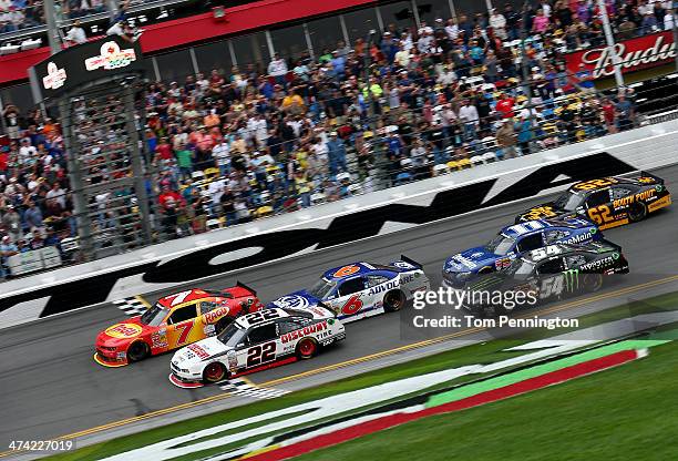 Regan Smith, driver of the Ragu Chevrolet, crosses the finish line ahead of Brad Keselowski, driver of the Discount Tire Ford, to win the NASCAR...