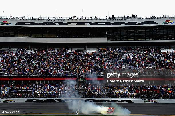 Regan Smith, driver of the Ragu Chevrolet, celebrates with a burnout after winning the NASCAR Nationwide Series DRIVE4COPD 300 at Daytona...