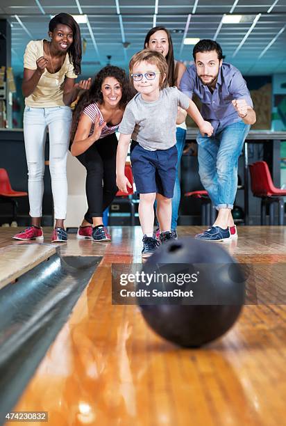 child throwing a bowling ball. - kids bowling stock pictures, royalty-free photos & images