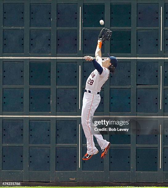 Colby Rasmus of the Houston Astros leaps a the wall but can't make the catch on a fly ball by Brett Lawrie of the Oakland Athletics in the eighth...