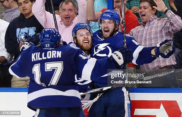 Nikita Kucherov of the Tampa Bay Lightning celebrates with his teammate Nikita Nesterov and Alex Killorn after scoring the game winning goal in...