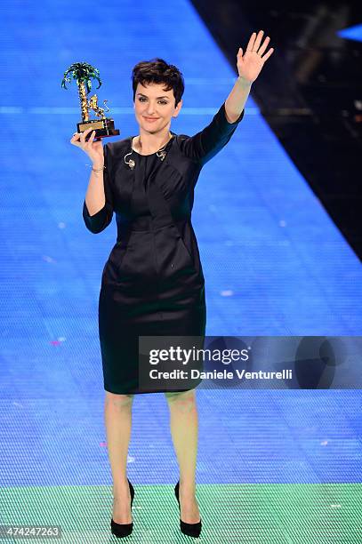 Italian singer Arisa, winner of the 64th Italian Music Festival in Sanremo, poses with his trophy at the Ariston theatre during the closing night on...