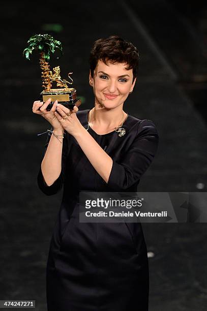 Italian singer Arisa, winner of the 64th Italian Music Festival in Sanremo, poses with his trophy at the Ariston theatre during the closing night on...
