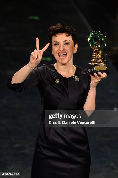 Italian singer Arisa, winner of the 64th Italian Music Festival in Sanremo, poses with his trophy at the Ariston theatre during the closing night on...