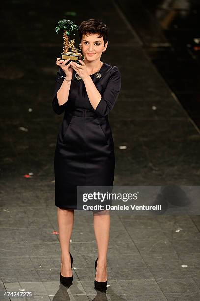 Italian singer Arisa, winner of the 64th Italian Music Festival in Sanremo, poses with his trophy at the Ariston theatre during the closing night on...