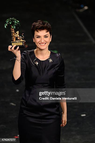 Italian singer Arisa, winner of the 64th Italian Music Festival in Sanremo, poses with his trophy at the Ariston theatre during the closing night on...