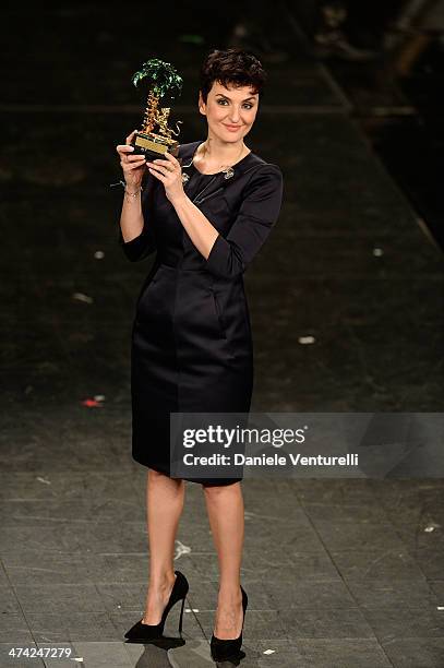 Italian singer Arisa, winner of the 64th Italian Music Festival in Sanremo, poses with his trophy at the Ariston theatre during the closing night on...