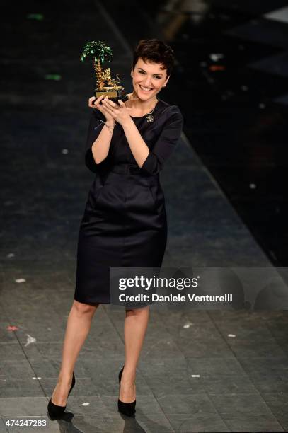 Italian singer Arisa, winner of the 64th Italian Music Festival in Sanremo, poses with his trophy at the Ariston theatre during the closing night on...