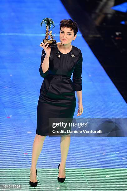 Italian singer Arisa, winner of the 64th Italian Music Festival in Sanremo, poses with his trophy at the Ariston theatre during the closing night on...