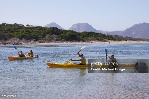 Shaun Burgoyne and Alex Woodward and Ben Ross and Brad Sewell go kayaking at Dophin Sands in front of the Hazards mountain range during the Hawthorn...