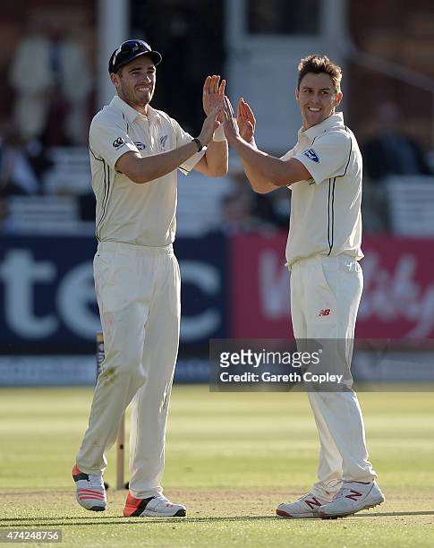 Trent Boult of New Zealand celebrates with Tim Southee after dismissing Jos Buttler of England during day one of 1st Investec Test match between...