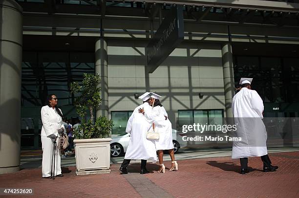 McDonogh Senior High School graduates hug following their commencement at the Ernest N. Morial Convention Center on May 14, 2015 in New Orleans,...