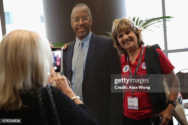 Supporter Becky Miller of Ardmore, Tennessee, poses for a photo with a cardboard cutout of Republican presidential hopeful Ben Carson during the 2015...