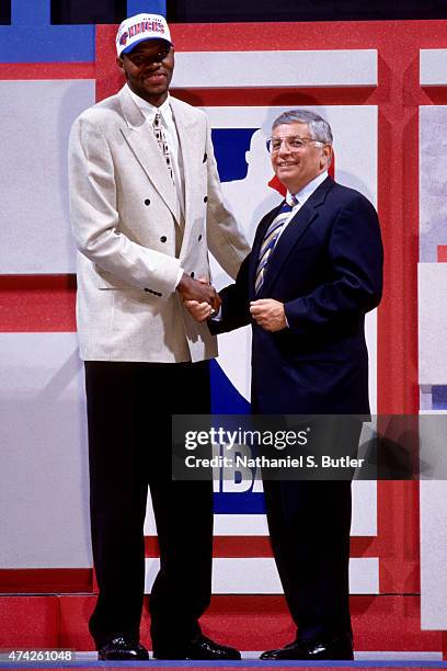 Walter McCarty of the New York Knicks shakes hands with Commissioner David Stern after getting drafted at the 1996 NBA Draft circa 1996 in East...