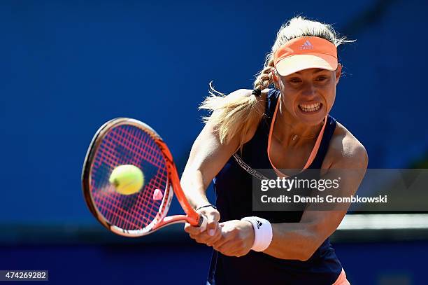 Angelique Kerber of Germany plays a backhand in her match against Misaki Doi of Japan during Day six of the Nuernberger Versicherungscup 2015 on May...