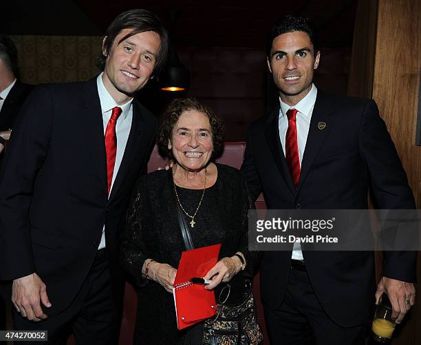 Tomas Rosicky and Mikel Arteta of Arsenal mingle with Arsenal super fan Maria at Arsenal's annual flagship fundraiser 'Night To Inspire' on Thursday...