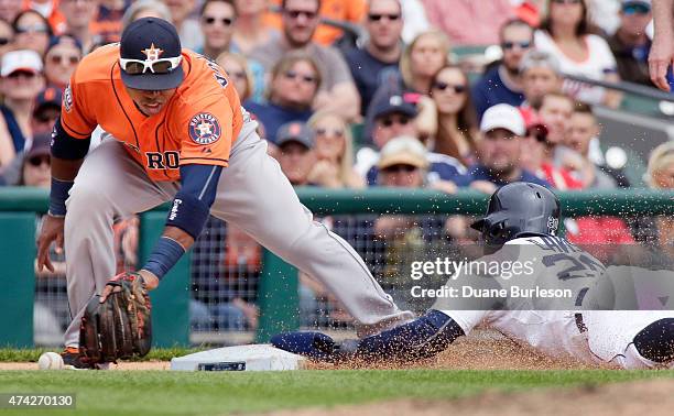 Rajai Davis of the Detroit Tigers steals third base as third baseman Luis Valbuena of the Houston Astros drops the ball during the sixth inning at...