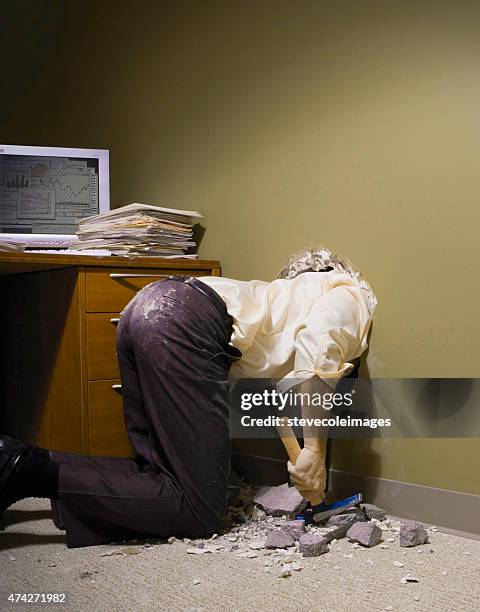 businessman with his head through a wall in his office. - escapism stock pictures, royalty-free photos & images