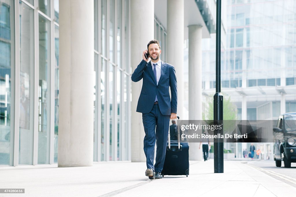 Businessman On His Cell Phone With Suitcase