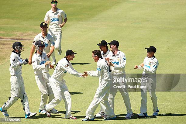 Adam Voges and Marcus North of the Warriors celebrate after dismissing Peter Nevill of the Blues during day four of the Sheffield Shield match...