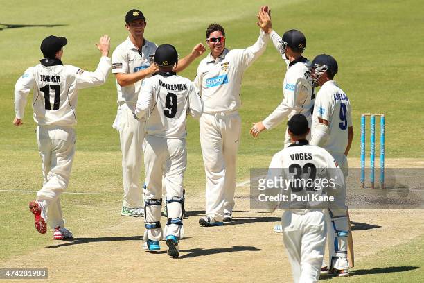 Marcus North of the Warriors is congratulated by team mates after dismissing Josh Hazlewood of the Blues during day four of the Sheffield Shield...
