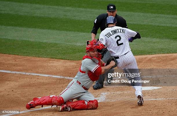 Troy Tulowitzki of the Colorado Rockies is tagged out at home plate by catcher Cameron Rupp of the Philadelphia Phillies as umpire Ryan Blakney...