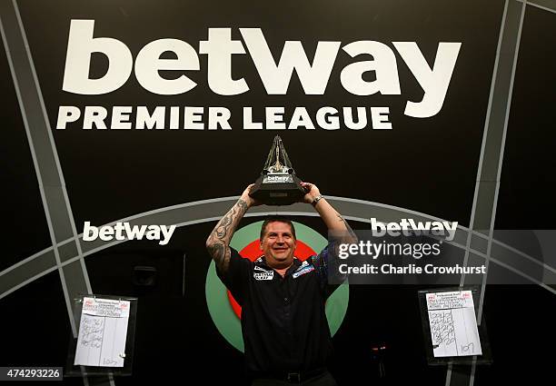 Gary Anderson of Scotland celebrates with the trophy after winning the Final against Michael van Gerwen of Holland during the Betway Premier League...